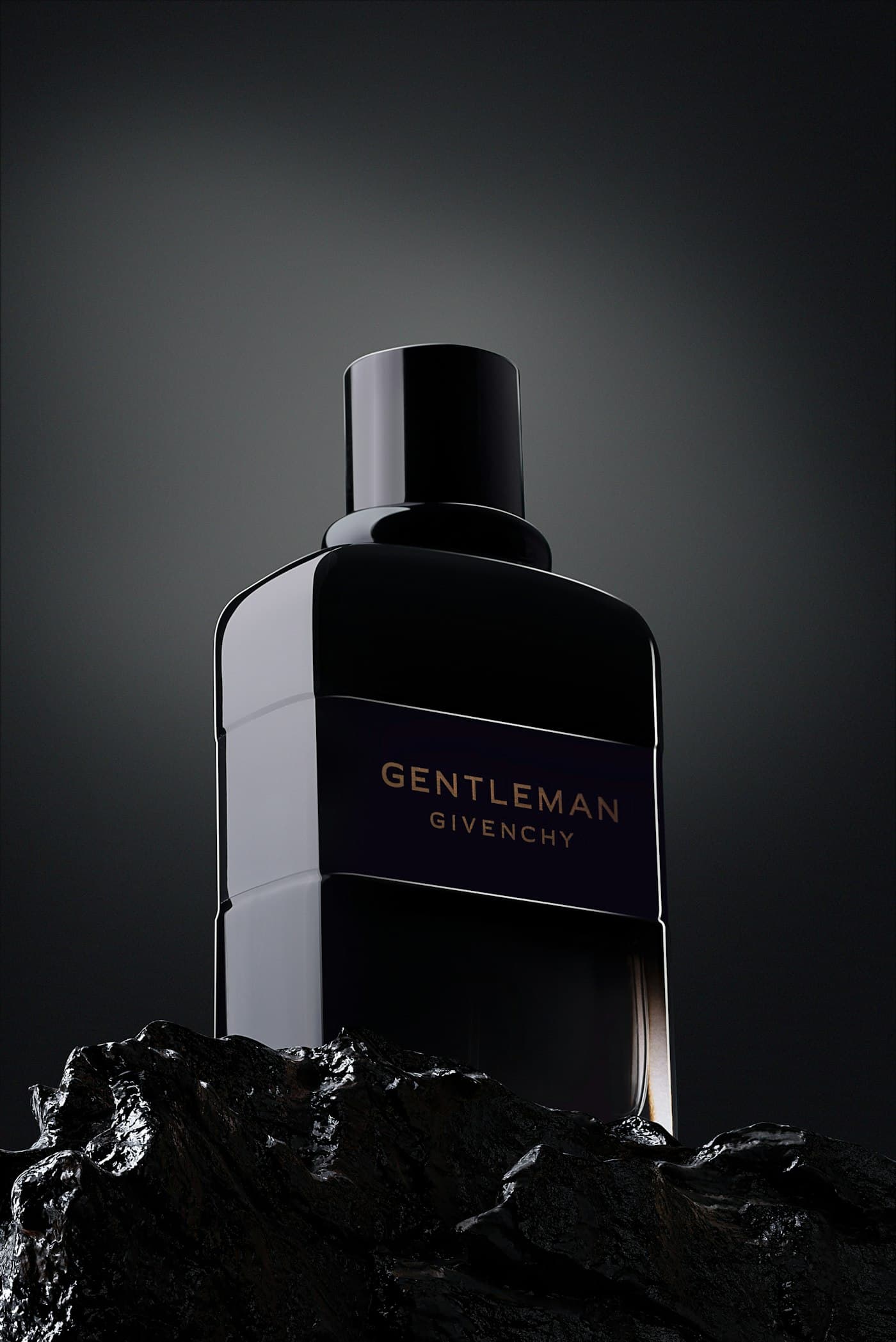 Backlit fragrance bottle photographed on black
